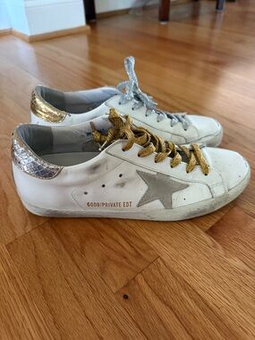 Golden Goose Superstars with silver and gold heel tabs